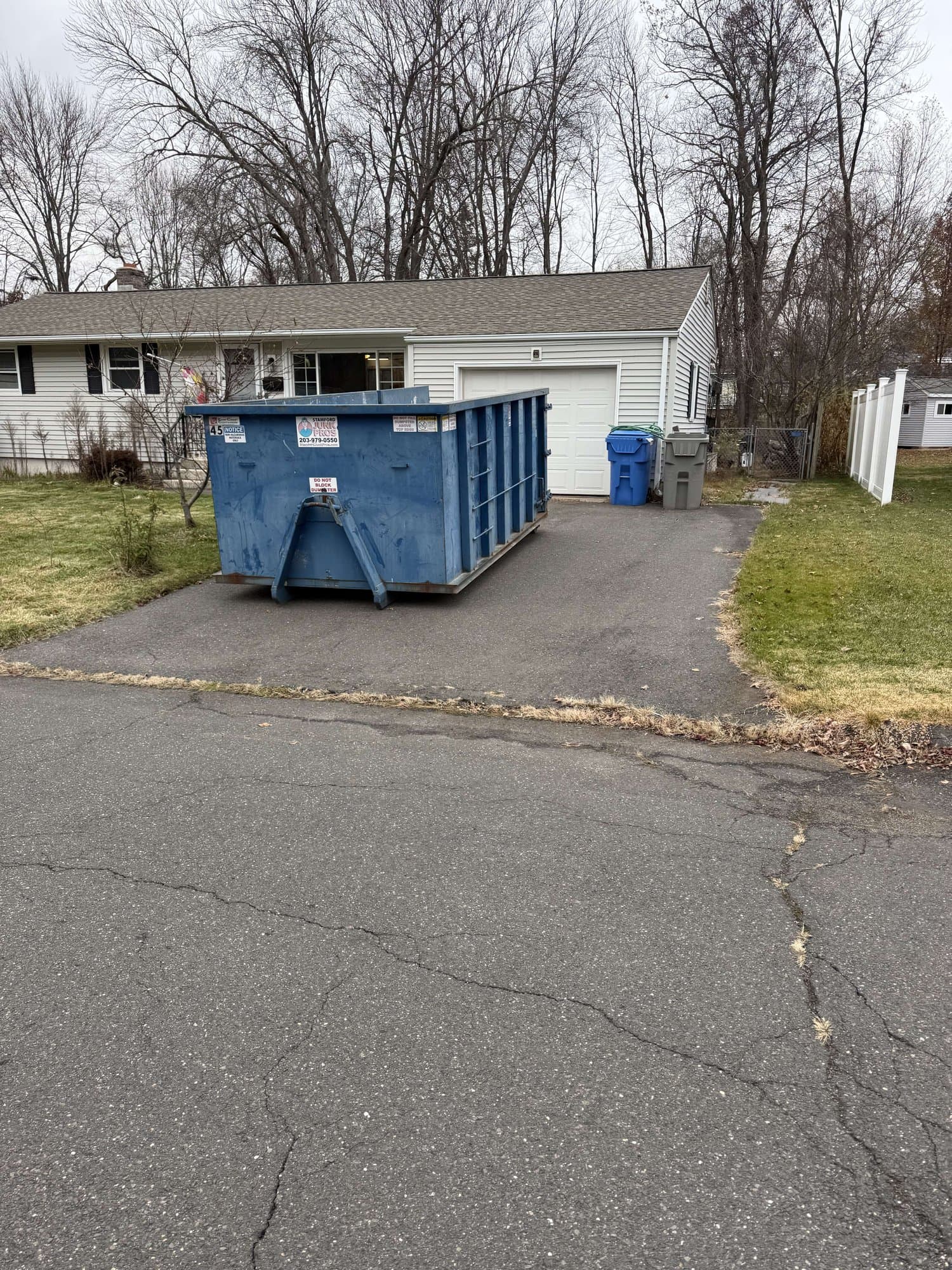 dumpster-on-driveway in Bristol, CT by Stamford Junk Pros