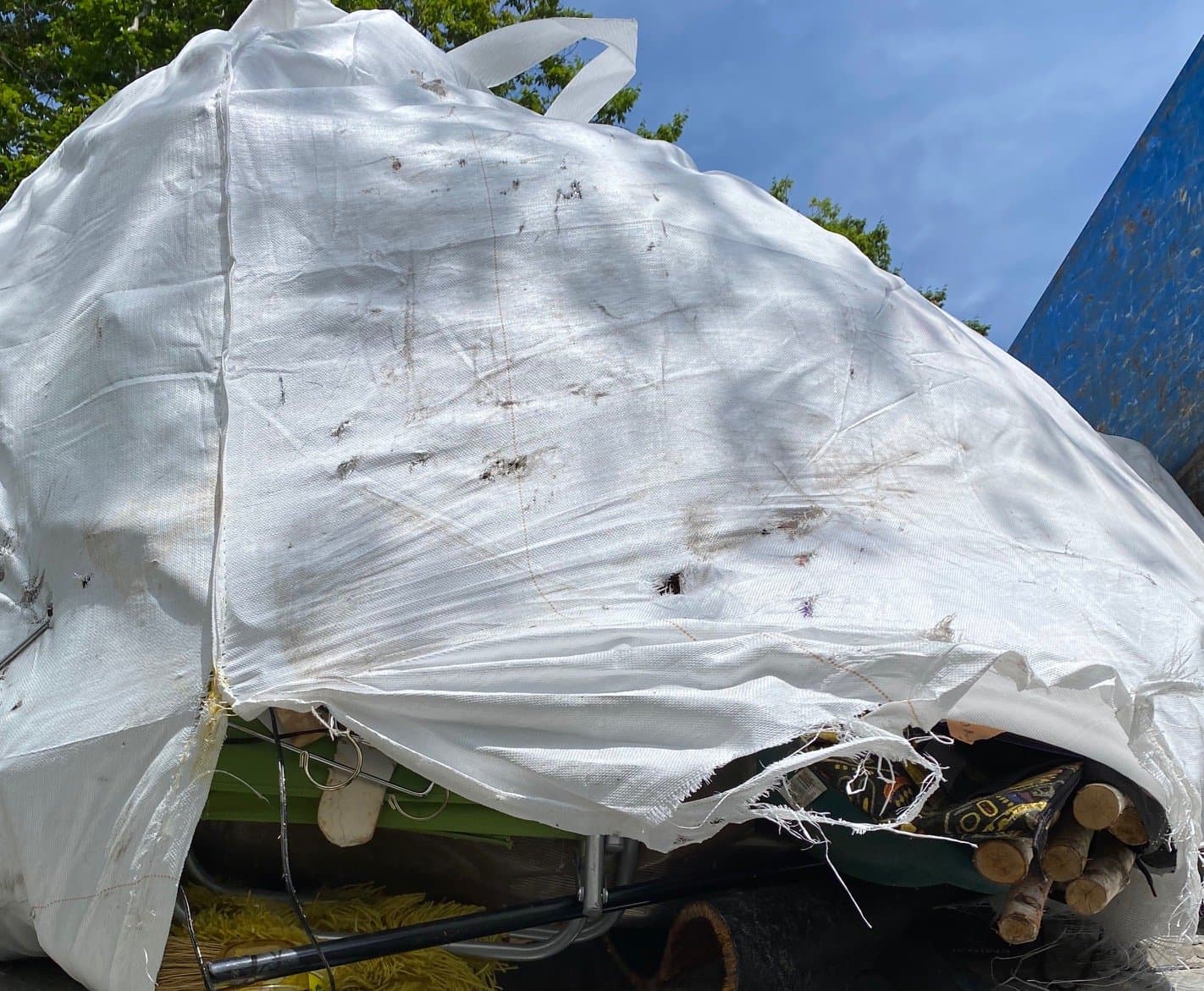 Dumpster filled with demolition debris and scrap materials during an active Grizzly Junk Pros job in Darien, CT
