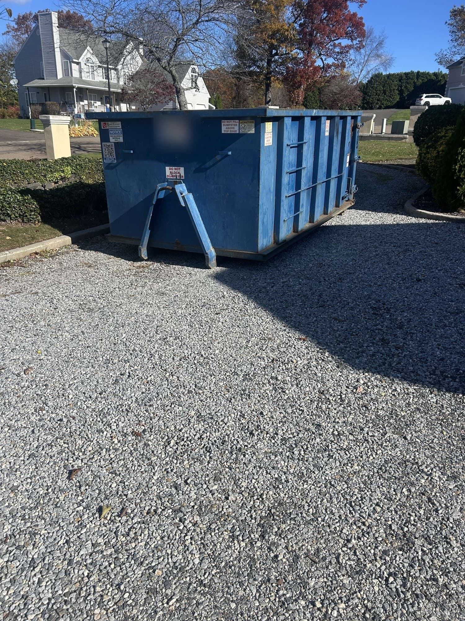 blue dumpster residential by Grizzly Junk Pros
