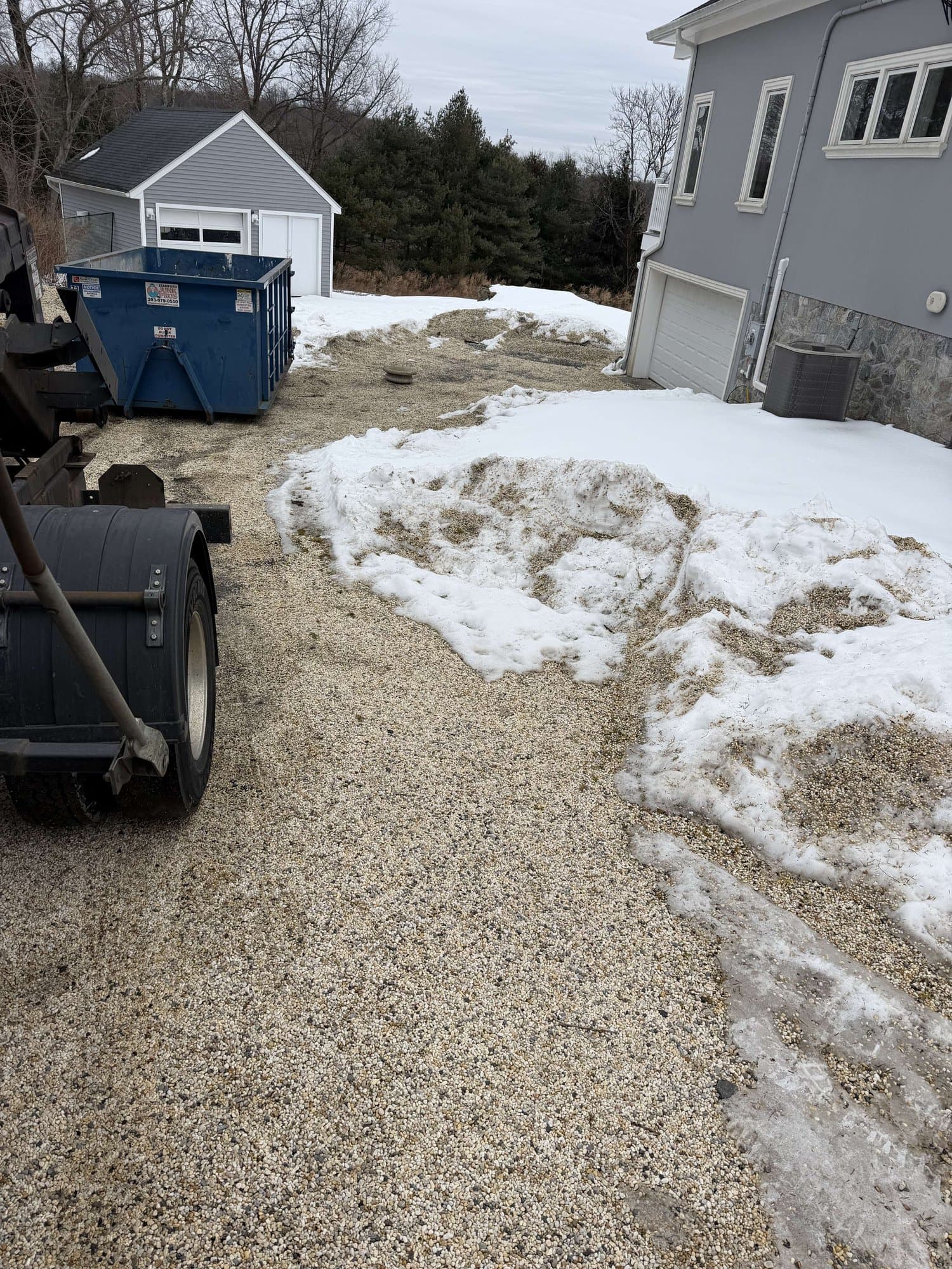 dumpster and debris in Greenwich, CT by Grizzly Junk Pros