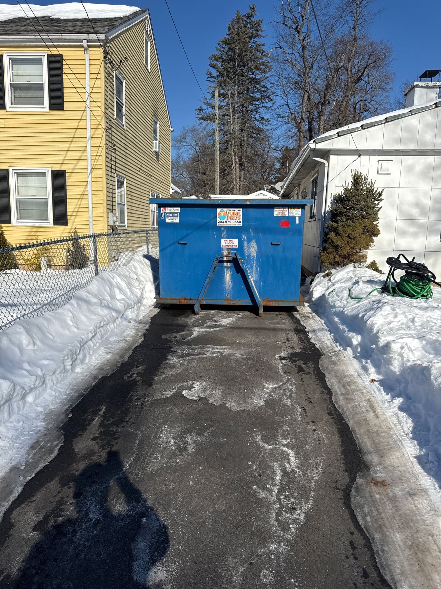 blue dumpster residential in Hartford, CT by Grizzly Junk Pros