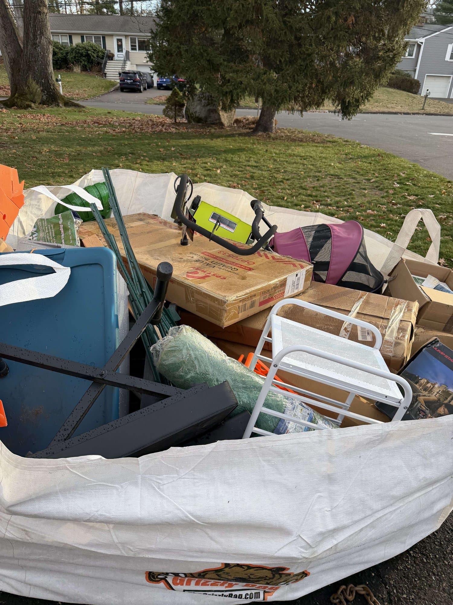 dumpster full mixed junk in Norwalk, CT by Grizzly Junk Pros