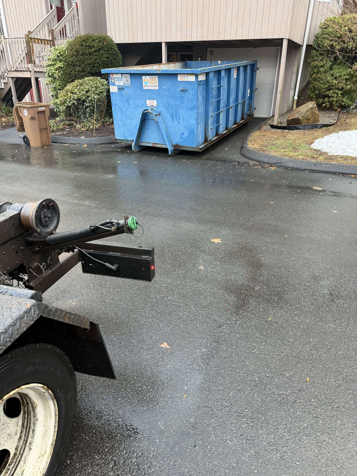 blue dumpster delivery in Shelton, CT by Grizzly Junk Pros