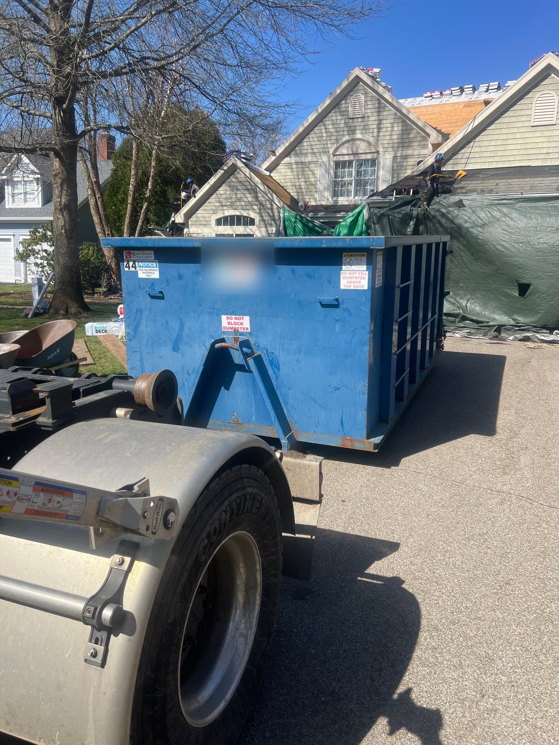 blue dumpster residential by Grizzly Junk Pros