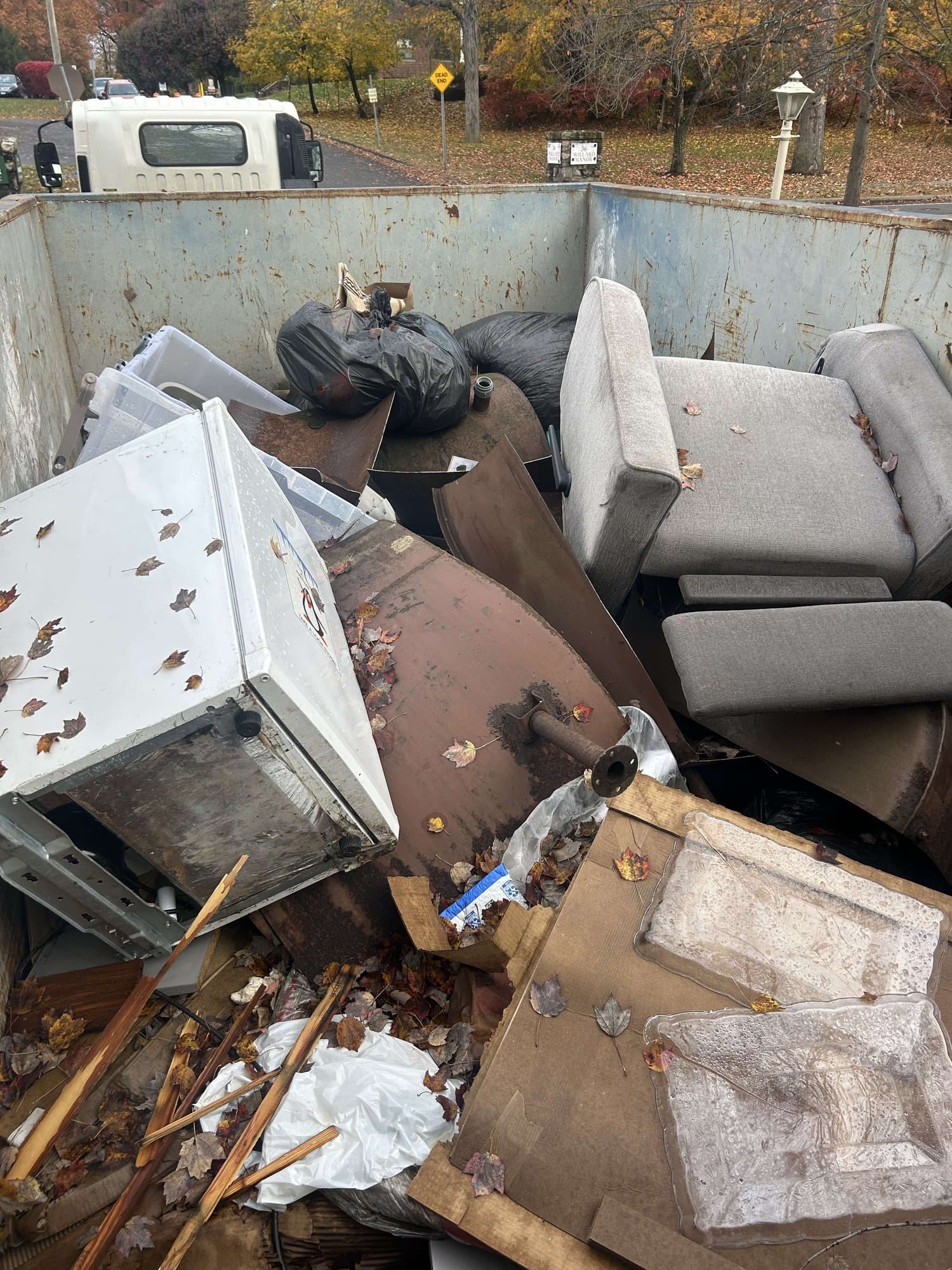 dumpster full furniture removal in Stamford, CT by Grizzly Junk Pros