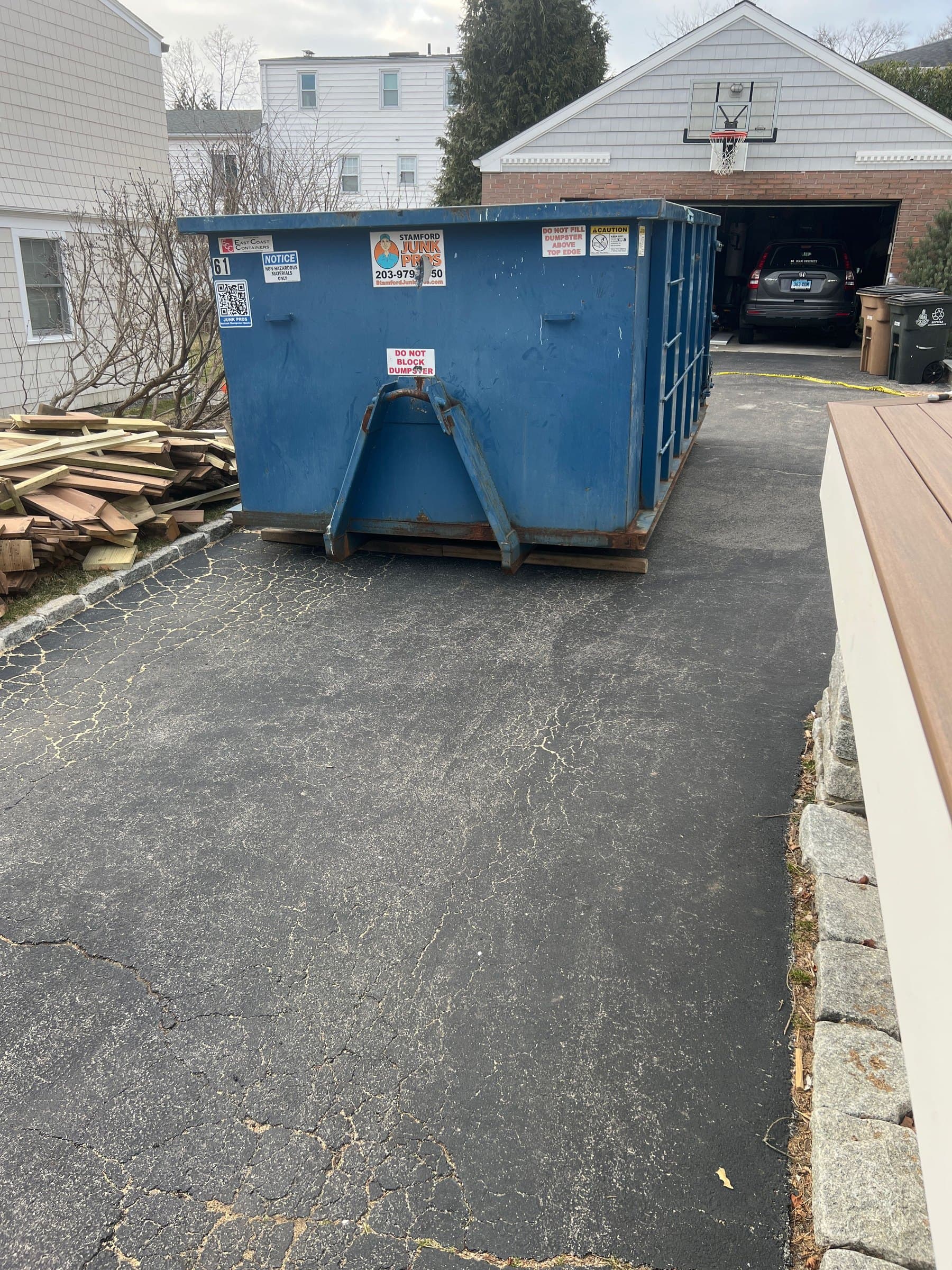 dumpster with debris in Stamford, CT by Grizzly Junk Pros