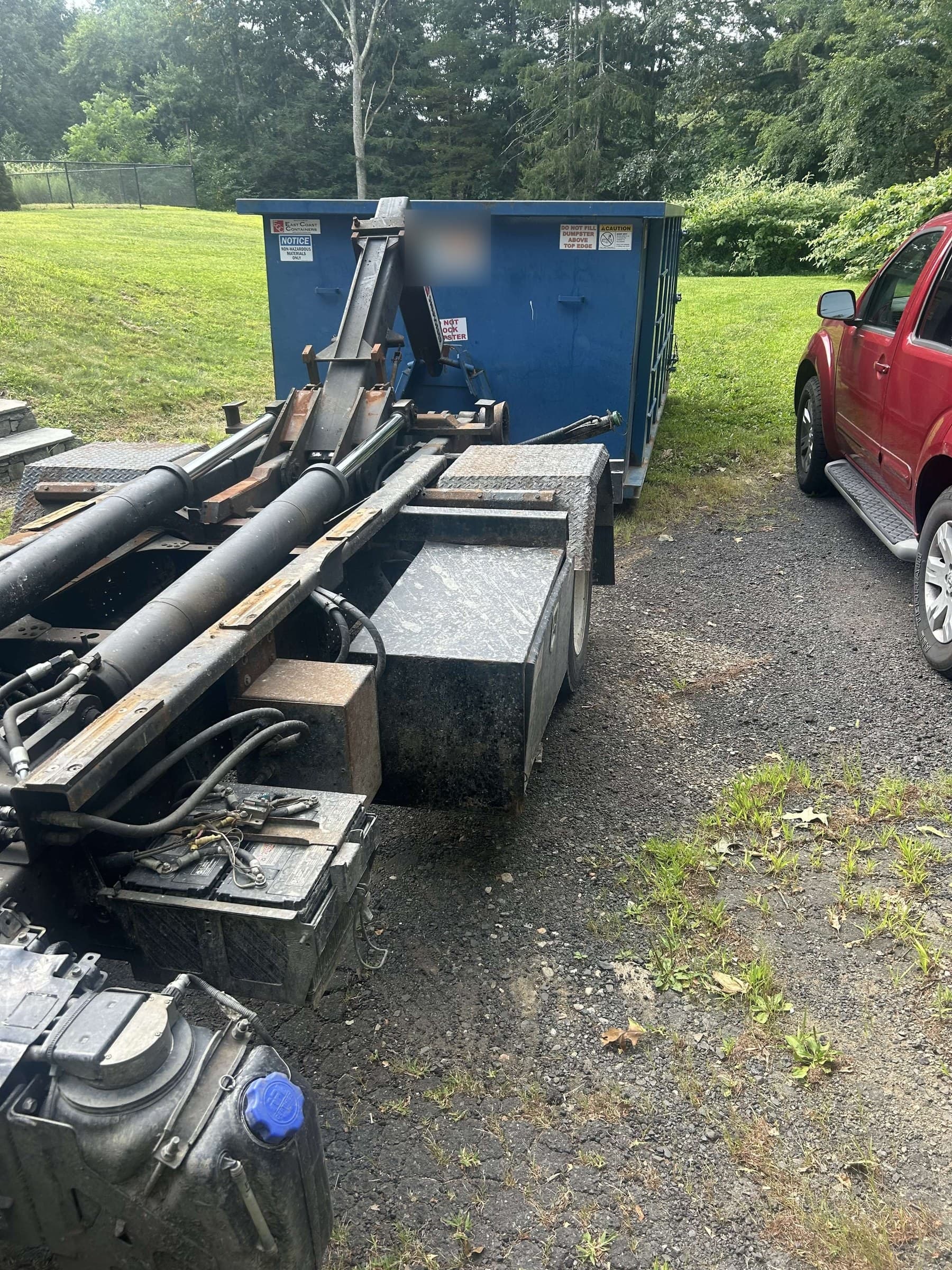 dumpster truck loading by Grizzly Junk Pros