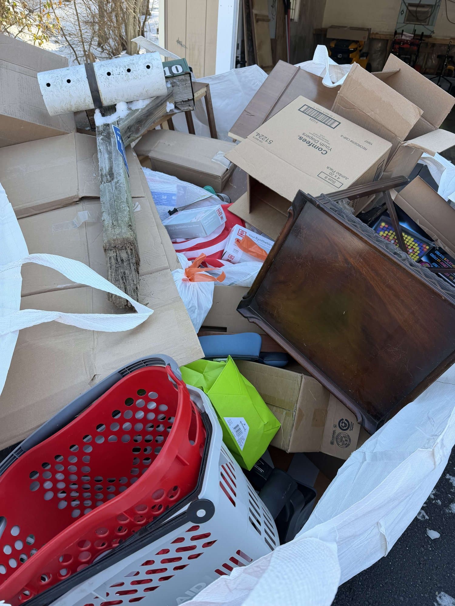 Boxes and storage bins being cleared and loaded during a Grizzly Junk Pros cleanout