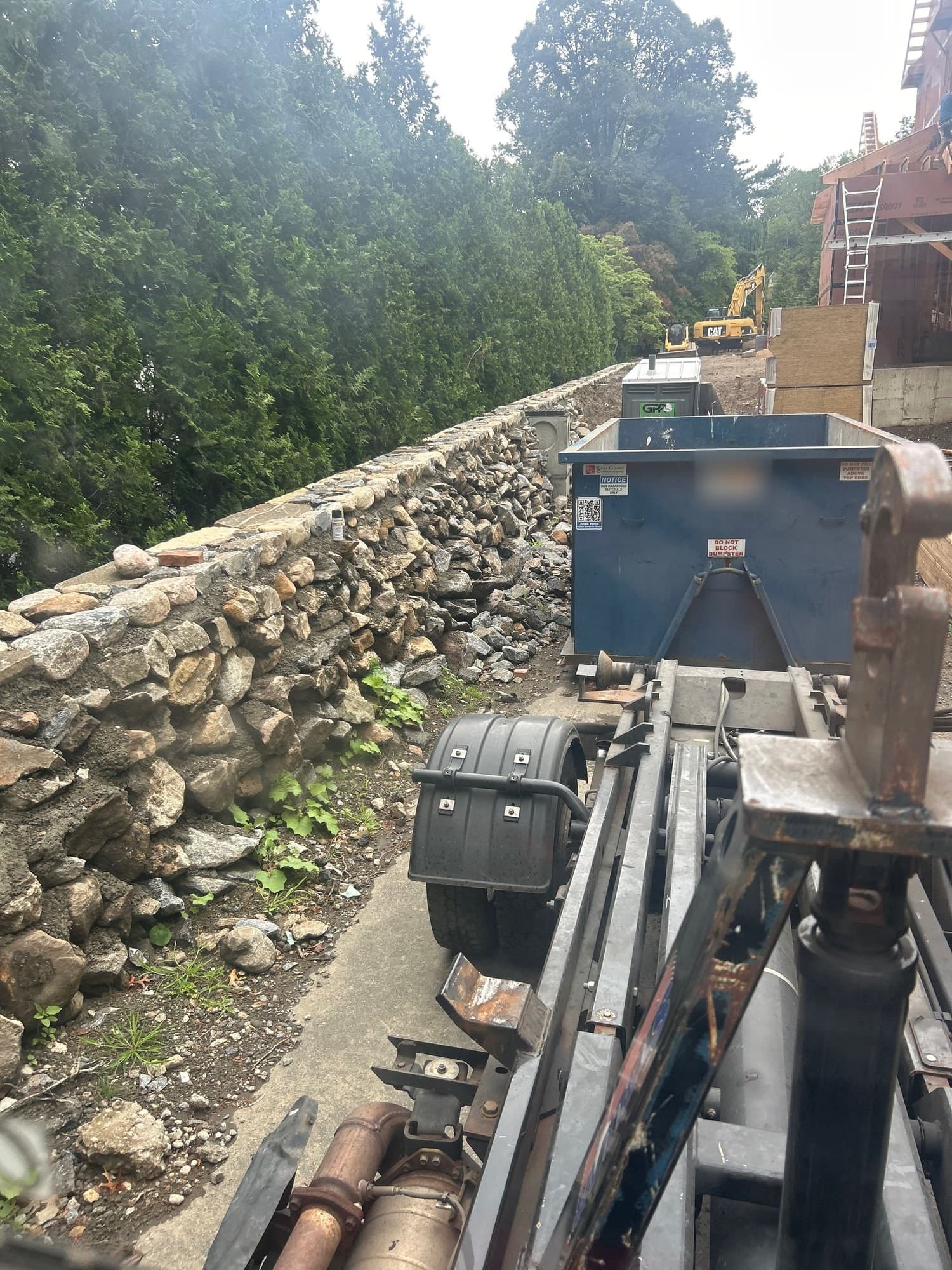 demolition dumpster site by Grizzly Junk Pros