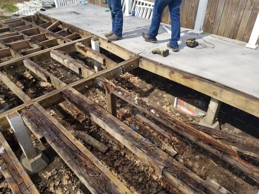 Severely rotted deck framing and damaged wood being removed during a Grizzly Junk Pros demolition