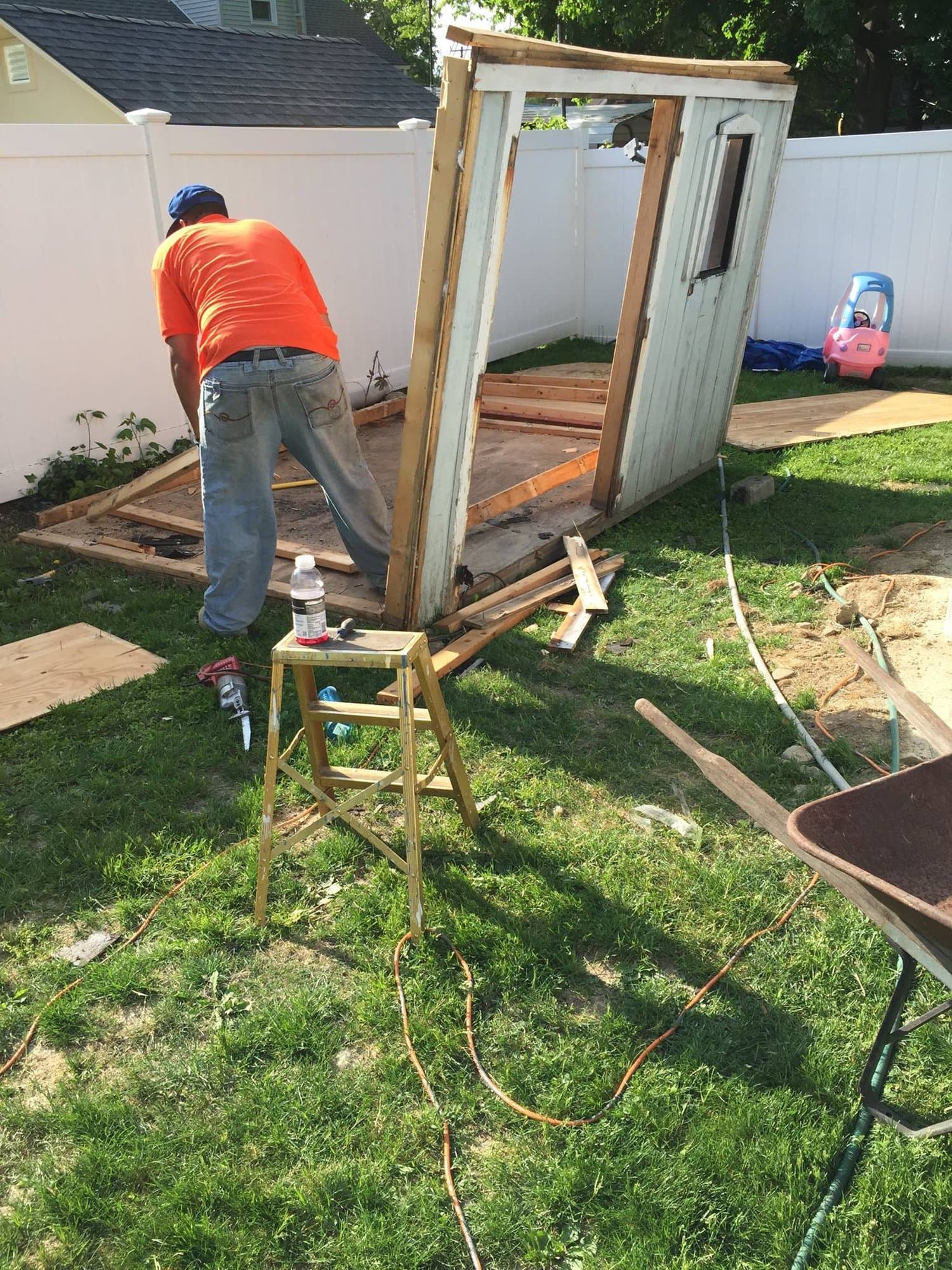 Grizzly Junk Pros crew member dismantling an old wooden shed during a demolition job