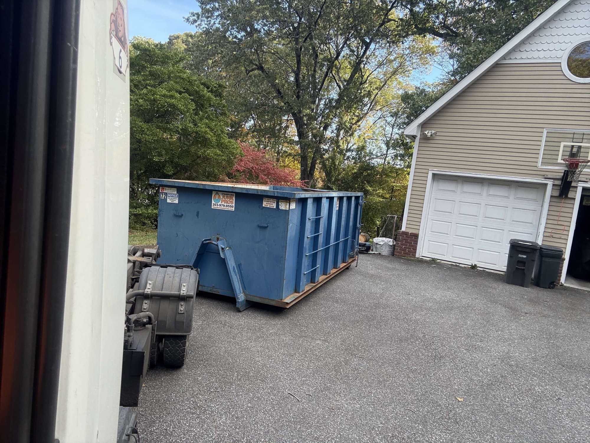 Roll-off dumpster delivery by Grizzly Junk Pros