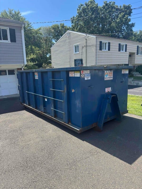 blue dumpster residential by Grizzly Junk Pros