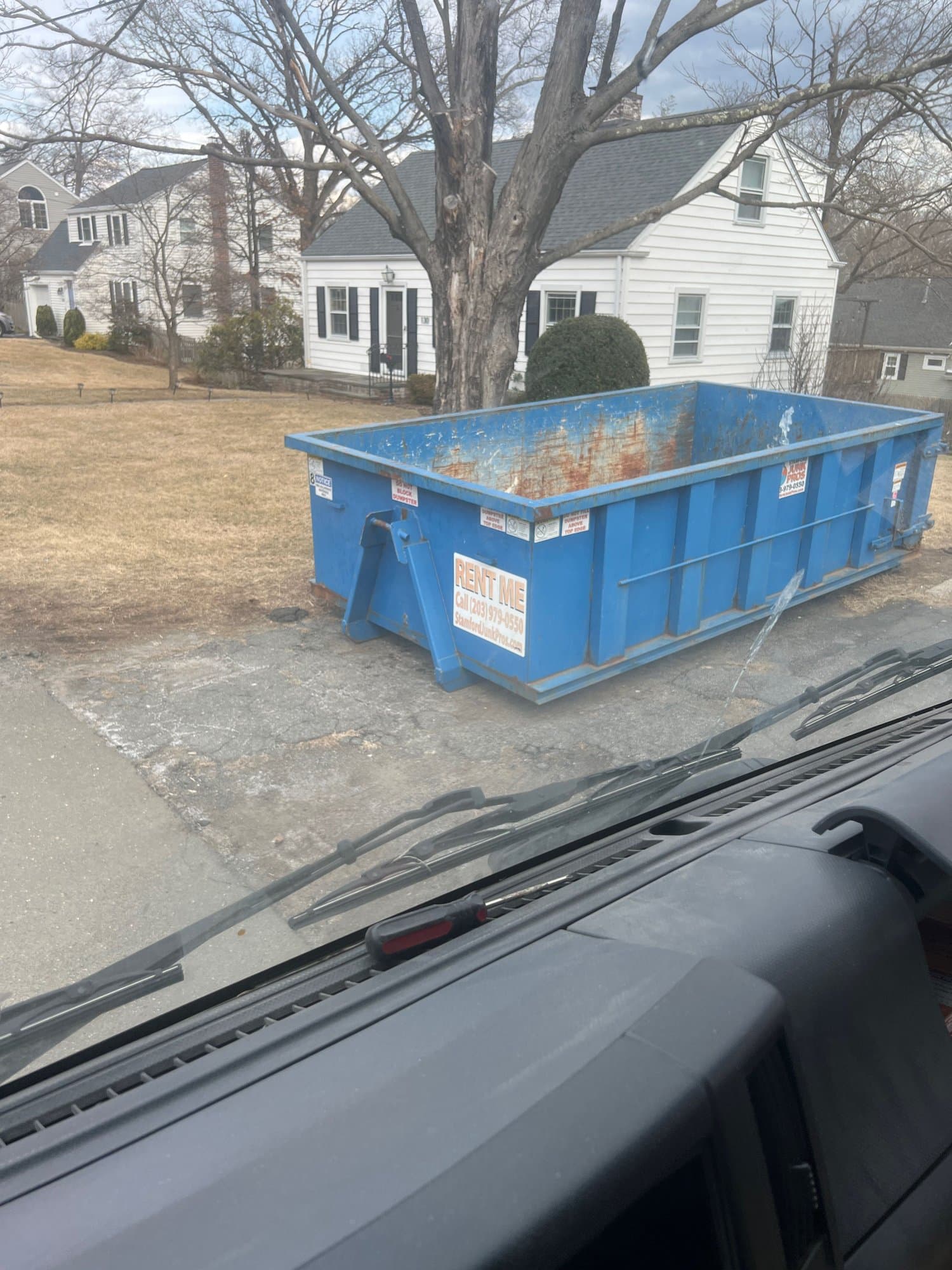 blue dumpster residential by Grizzly Junk Pros