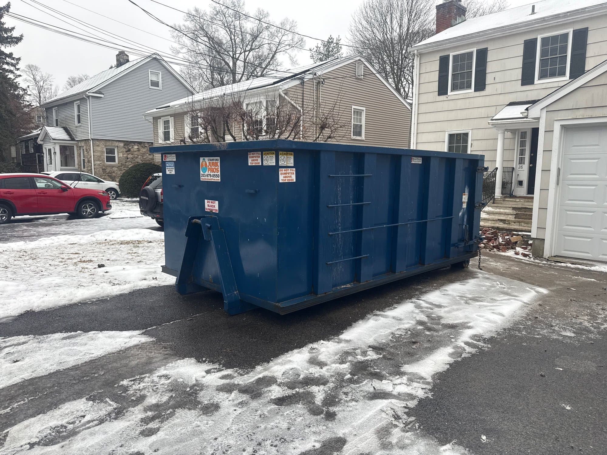Roll-off dumpster delivery by Grizzly Junk Pros