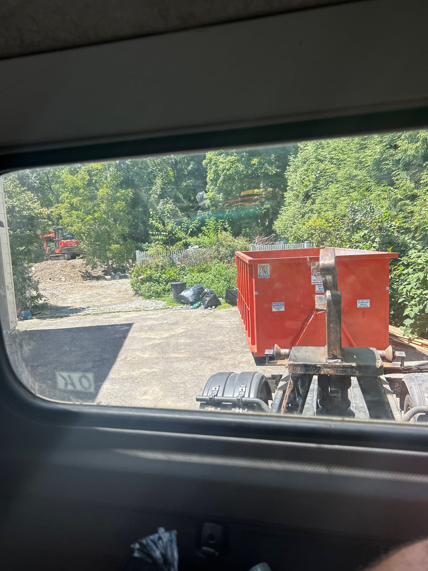 dumpsters on trailer by Grizzly Junk Pros