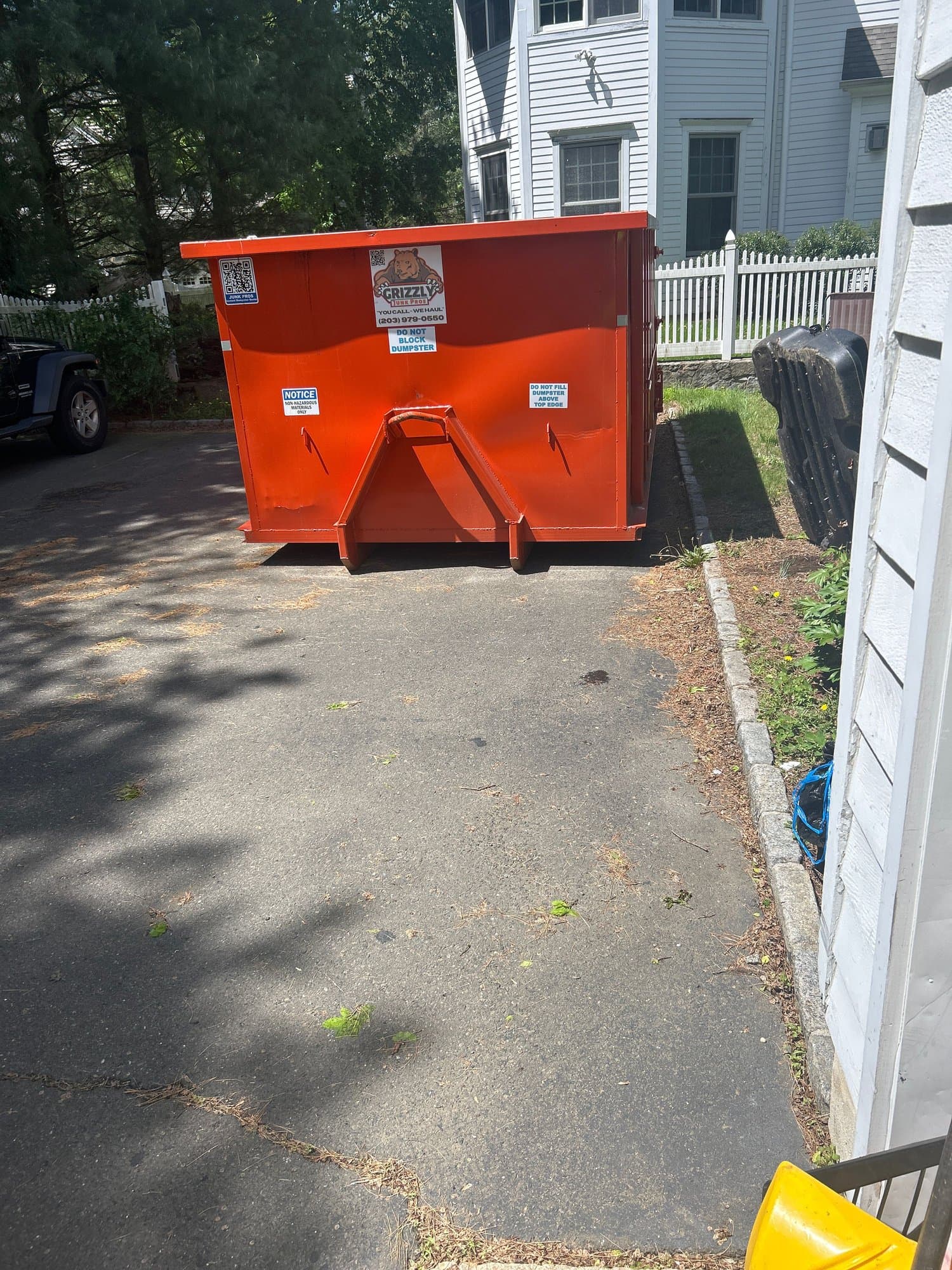 orange dumpster placement by Grizzly Junk Pros