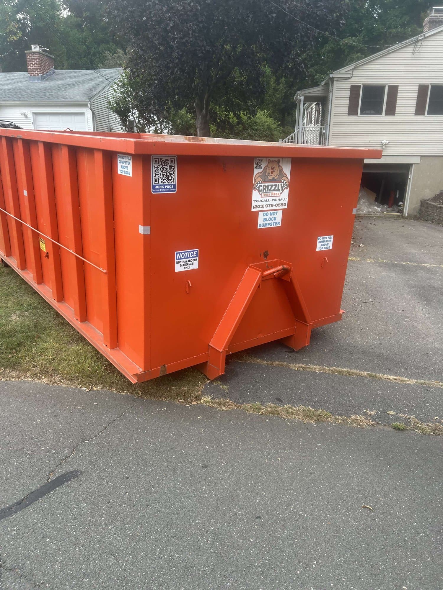 orange dumpster residential by Grizzly Junk Pros