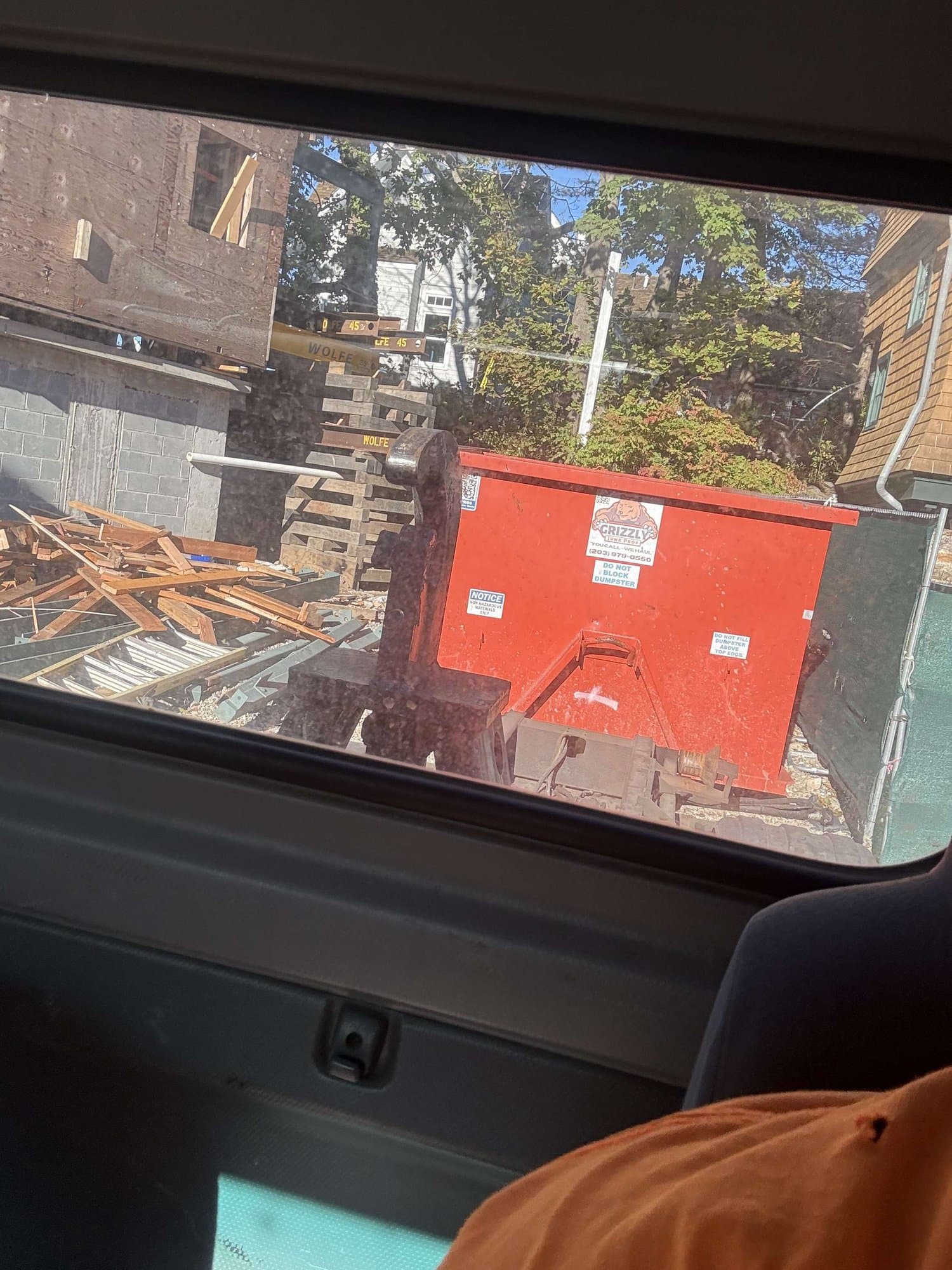 red dumpster debris removal by Grizzly Junk Pros