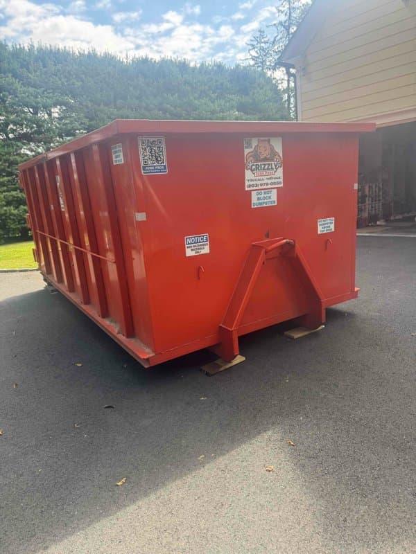 red dumpster delivery by Grizzly Junk Pros