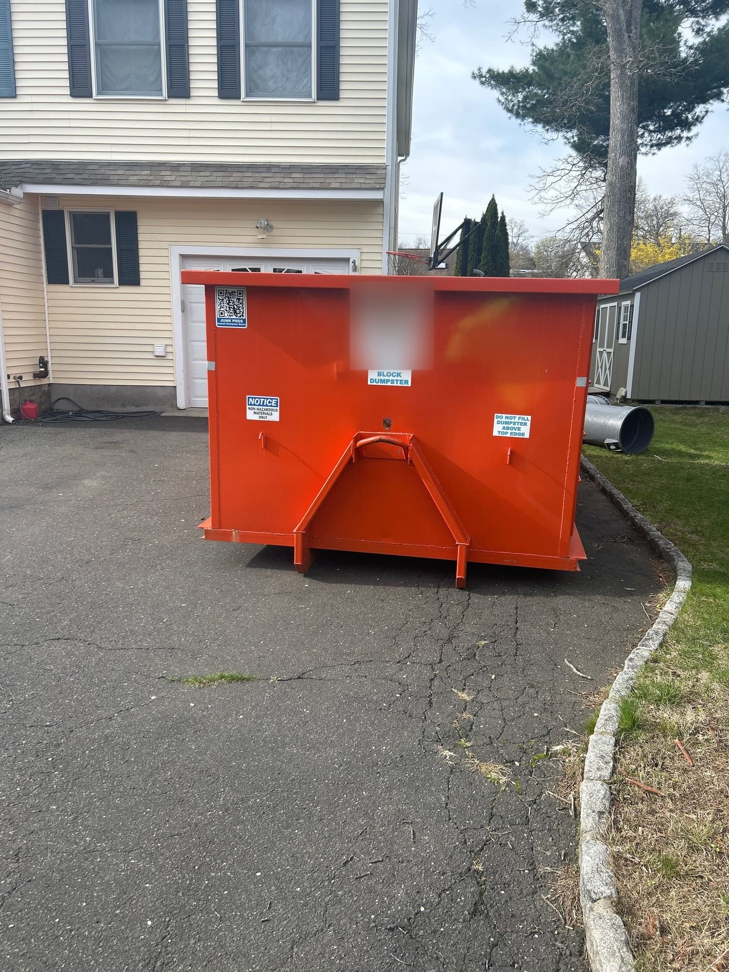 red dumpster delivery by Grizzly Junk Pros