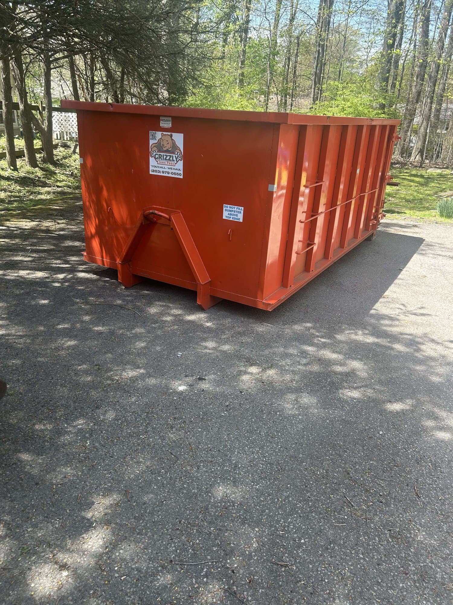 red dumpster rental by Grizzly Junk Pros