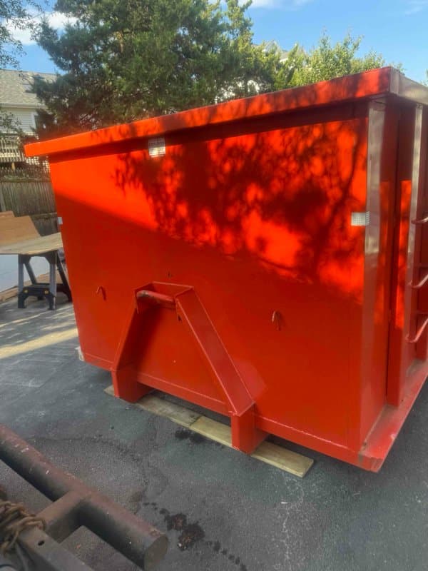 red dumpster residential by Grizzly Junk Pros