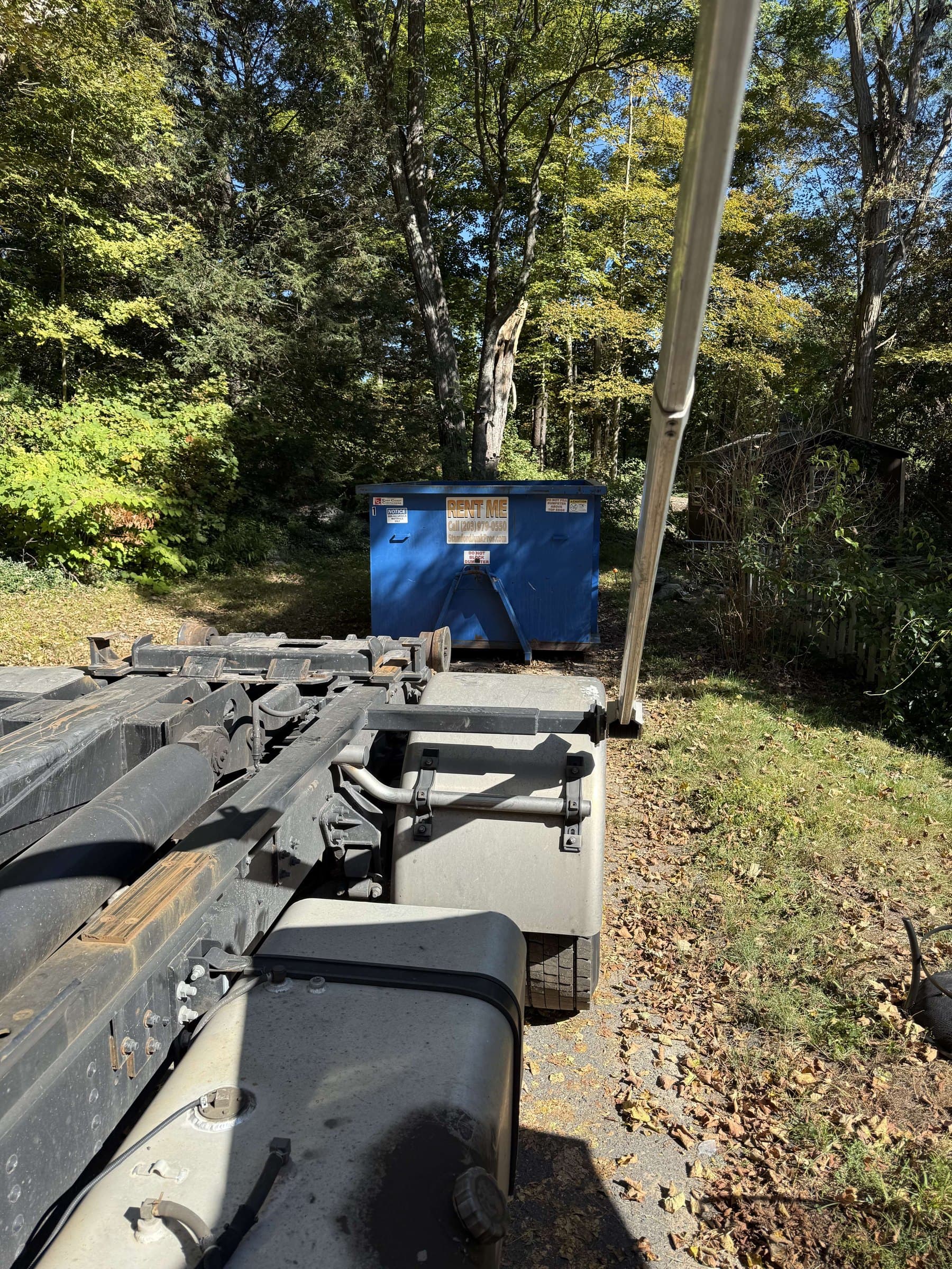 dumpster and truck hauling by Grizzly Junk Pros