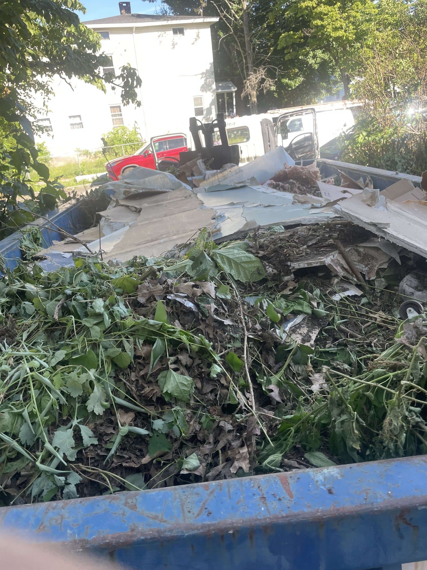 debris filled truck loading by Grizzly Junk Pros