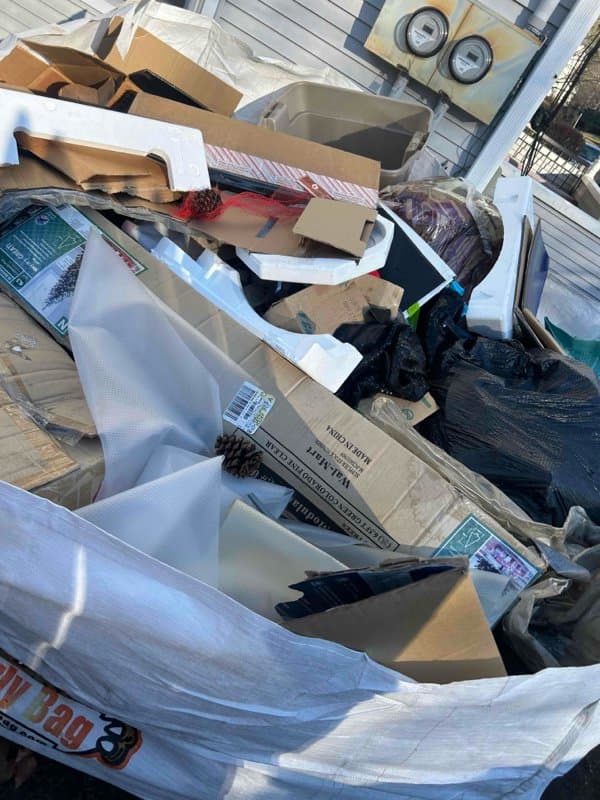dumpster full debris by Grizzly Junk Pros