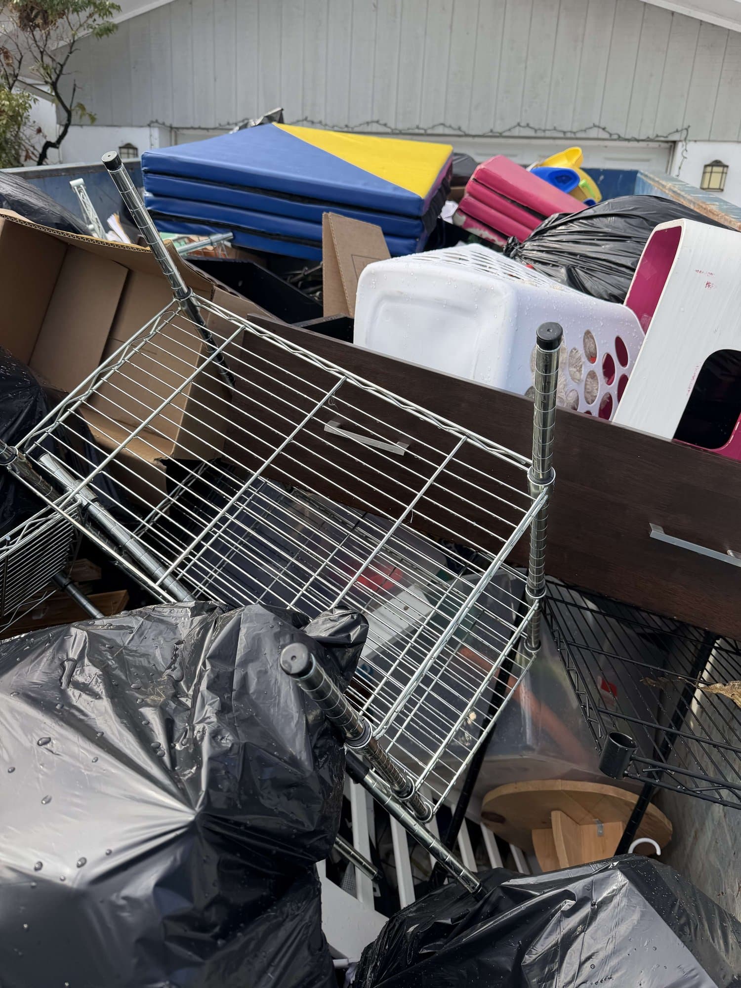 dumpster full junk load by Grizzly Junk Pros