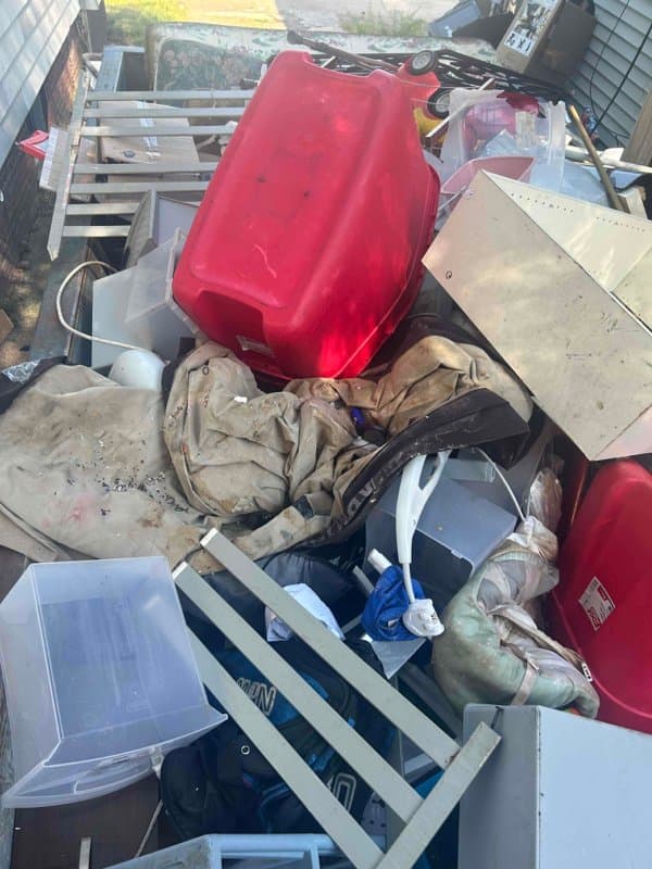 Mixed household items and storage bins loaded during a Grizzly Junk Pros removal