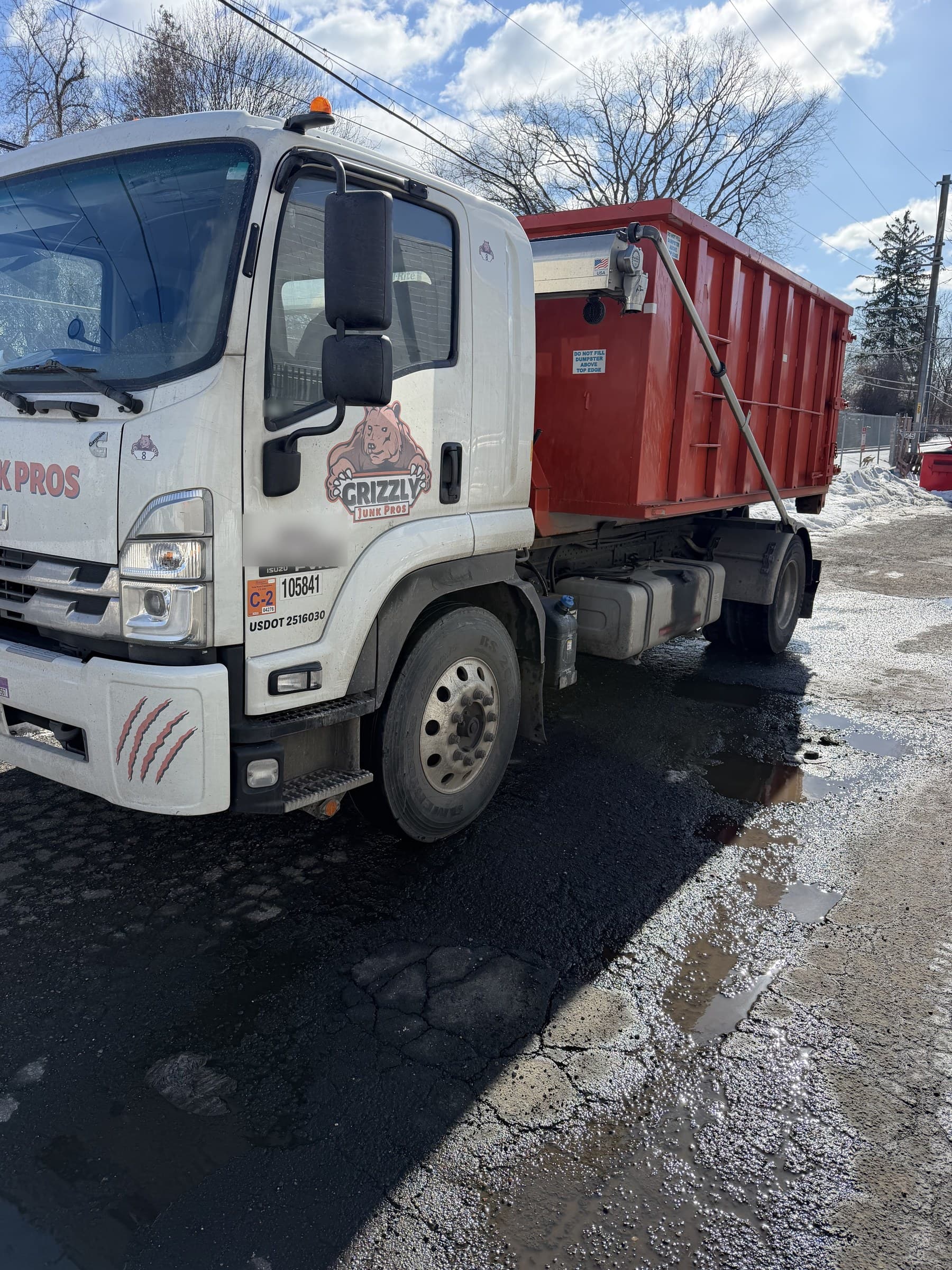 dumpster truck loading by Grizzly Junk Pros