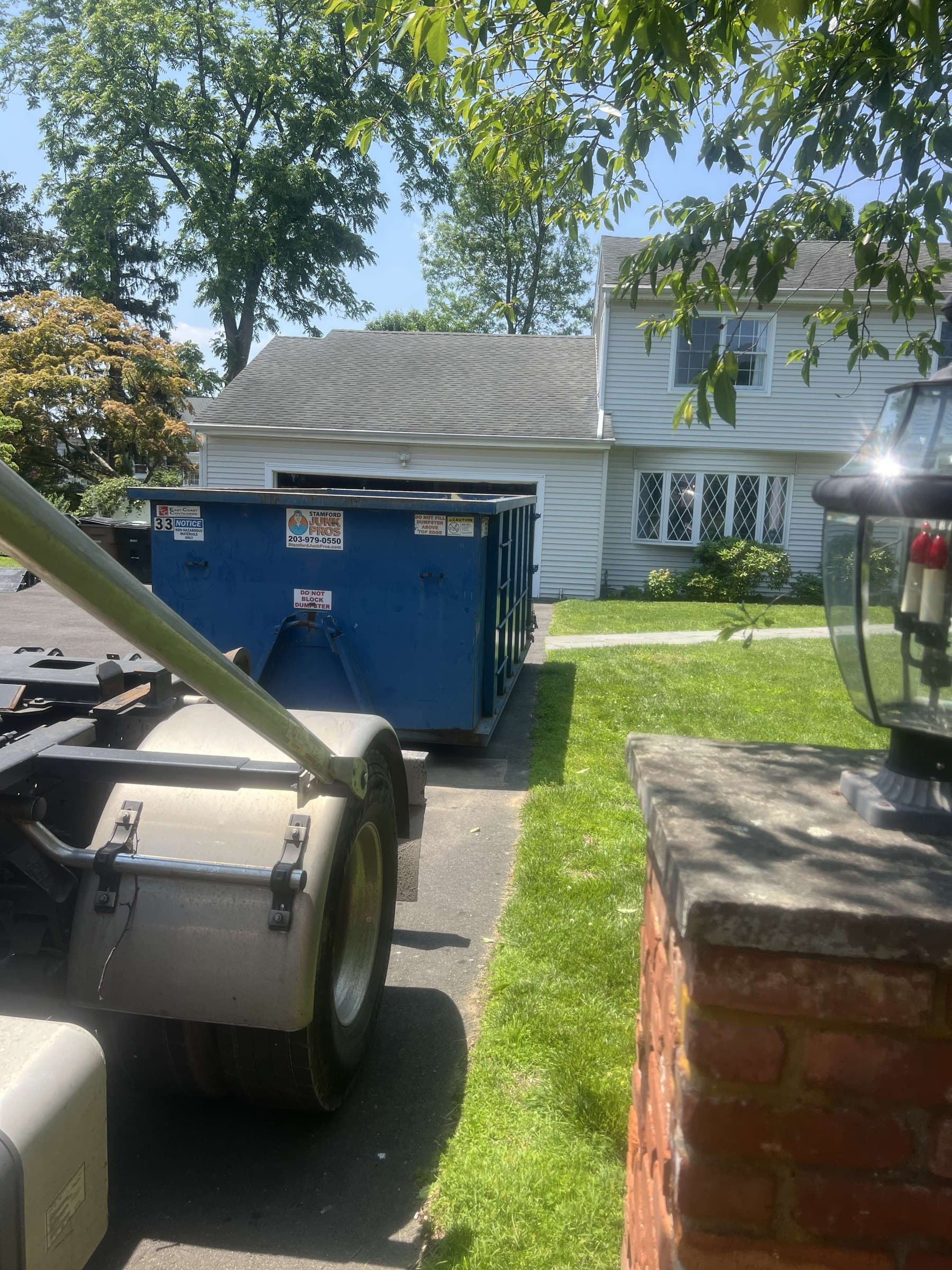 dumpster at residence in Weston, CT by Grizzly Junk Pros